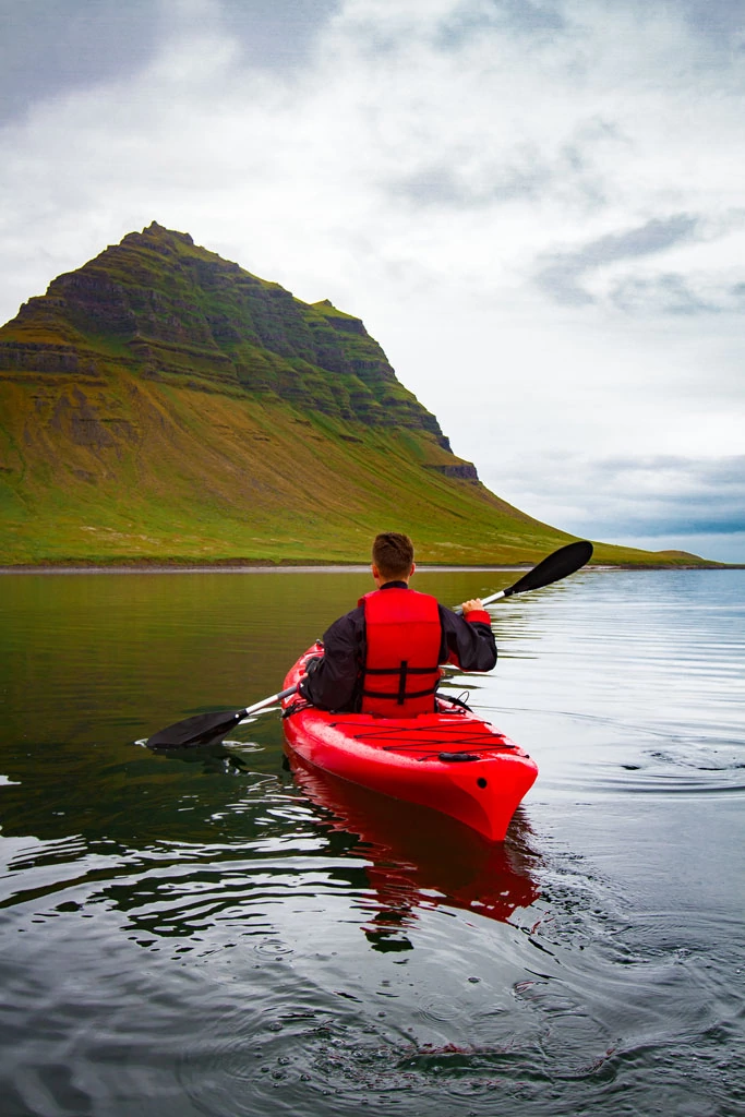 Kayaking in sea arounf kirkjufell mountain iceland